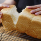 Hands tearing a Japanese shokupan bread